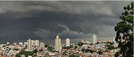 Parte de uma foto panorâmica batida por Lauro Sigalo em que mostra uma tempestade com o céu muito carregado de nuvens escuras sobre a cidade de São Paulo.